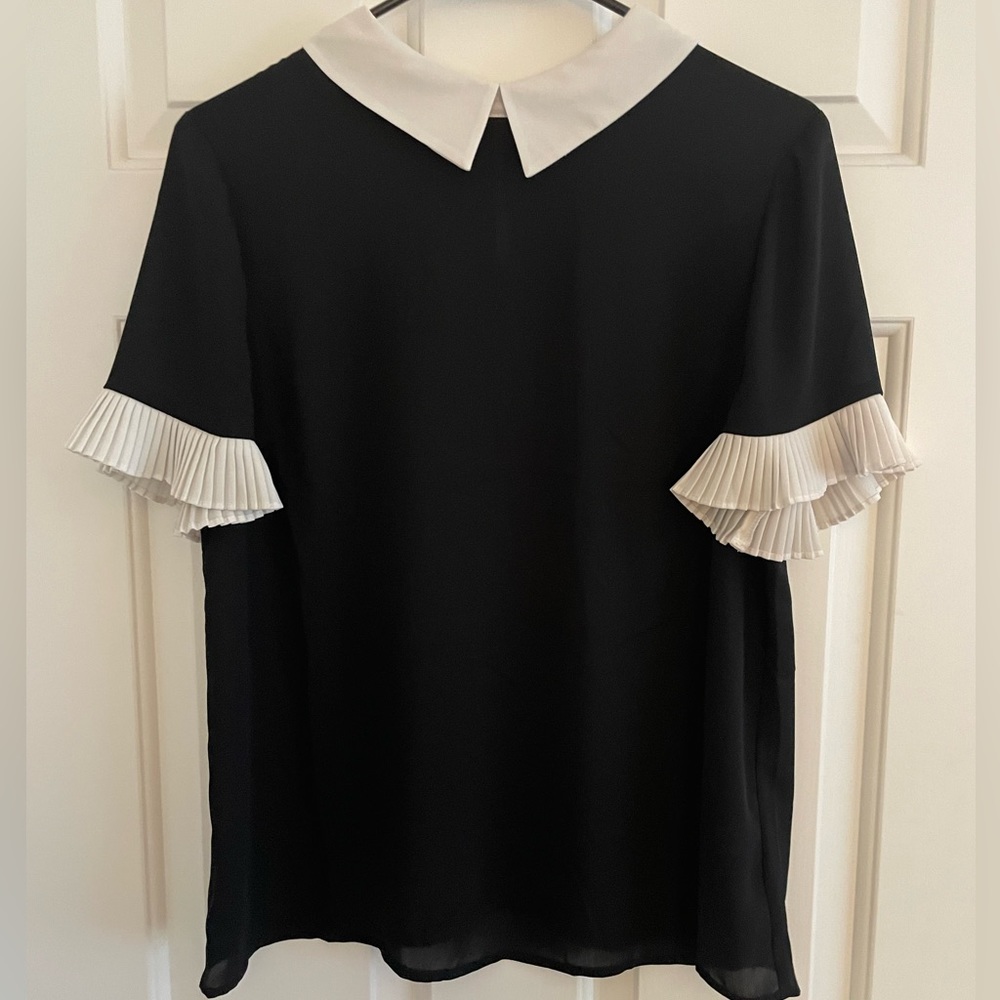 Black top with white flutter sleeves